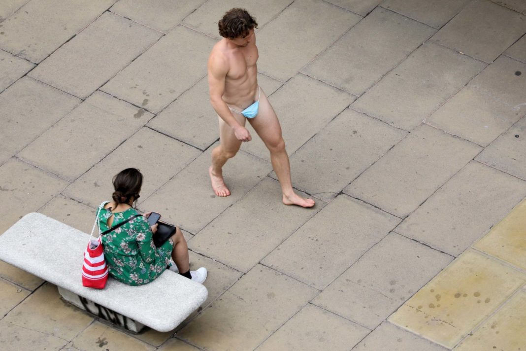man-walks-down-oxford-street-wearing-nothing-but-a-face-mask